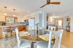 A spacious kitchen with a dining area, wooden flooring, and a ceiling fan. - Dock & Views: Waterfront Home in Wabasha! (Wabasha)