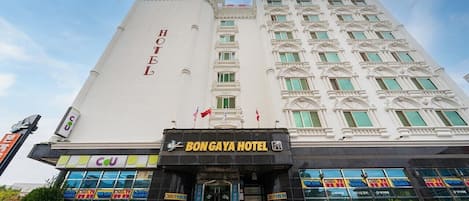 A large, multi-story hotel with a prominent 'HOTEL' sign on the facade.