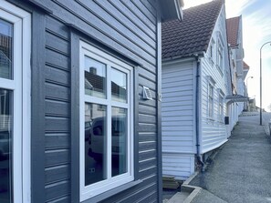 Situated on a quiet street, this home features a charming exterior with a red-tiled roof and double-hung windows.