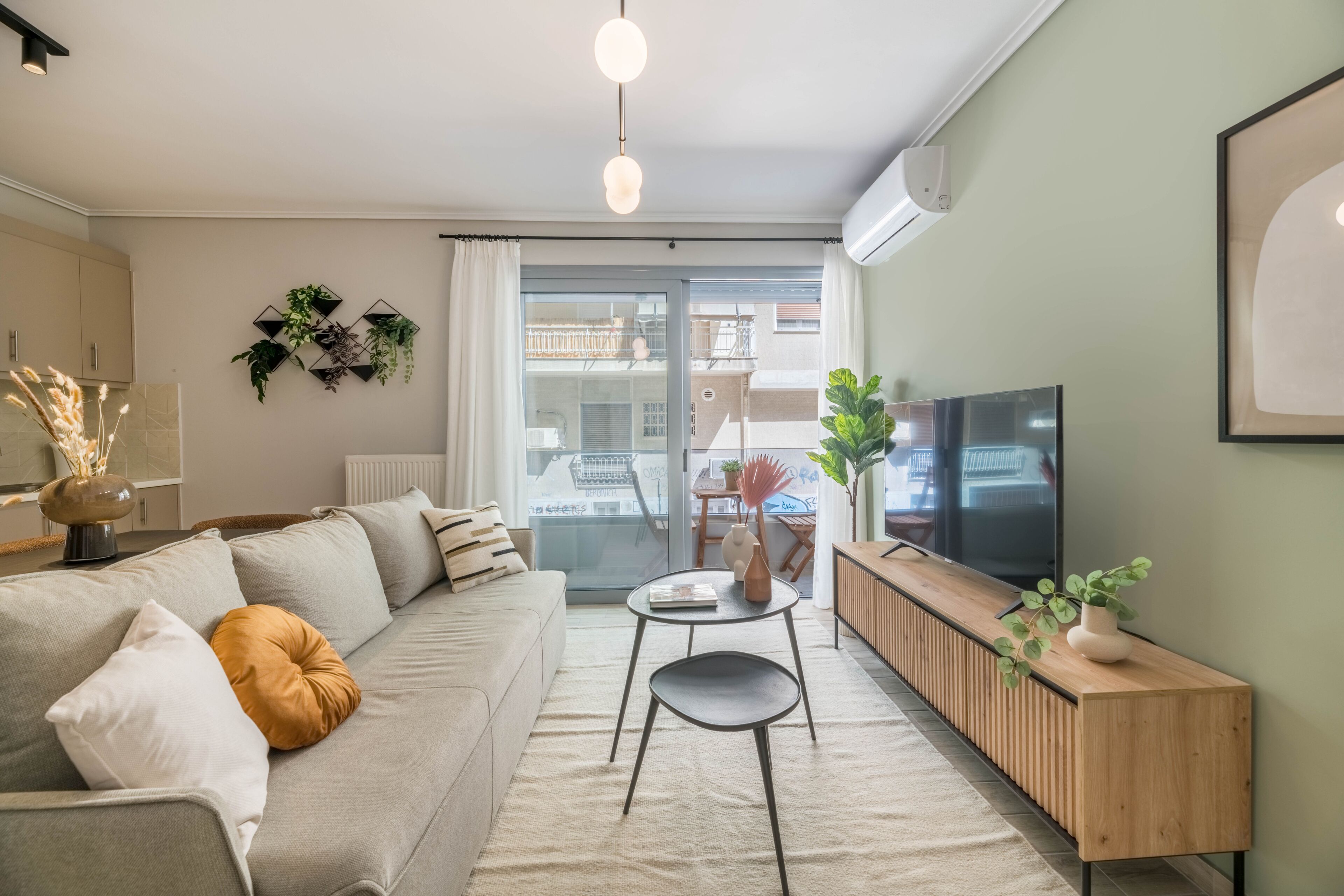 A modern living room with a sofa, a coffee table, a TV, and a wooden cabinet.