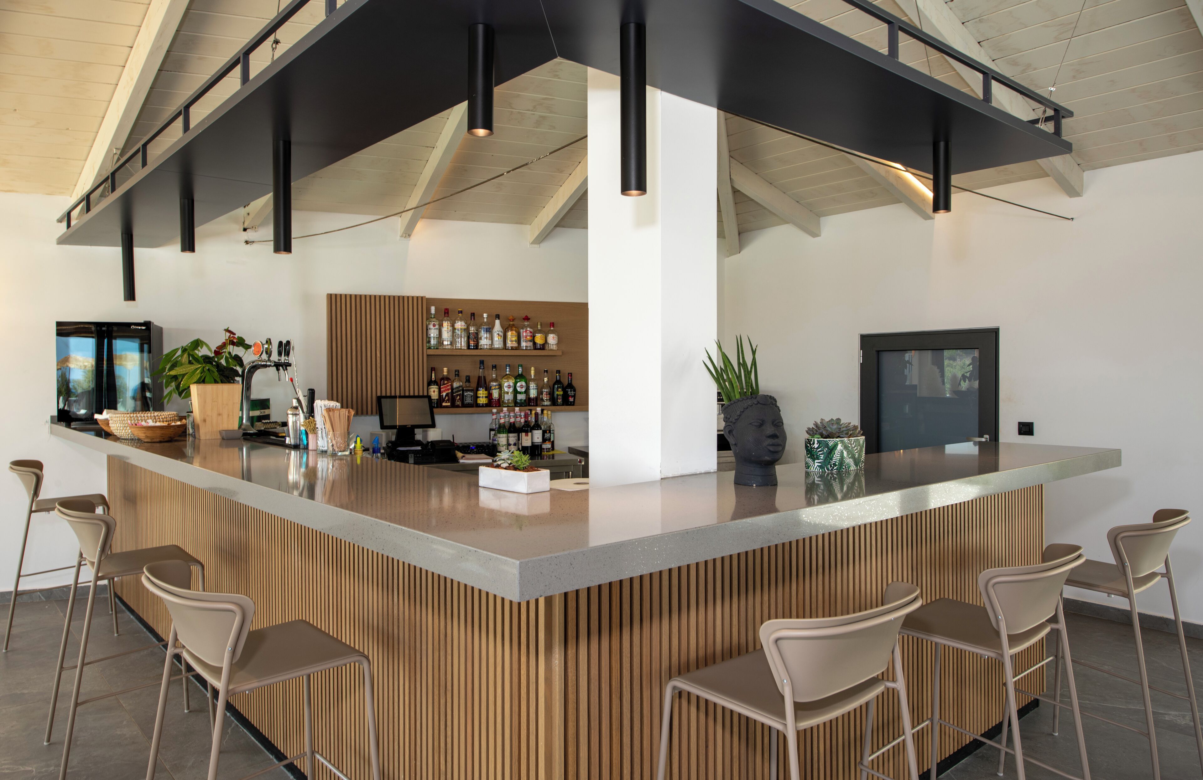 A modern kitchen with a central island, bar area, and seating.