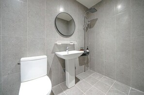 A modern bathroom with a toilet, sink, and shower. - From H Dongbaek Hotel By Kwon Geoje Okpo (Geoje)