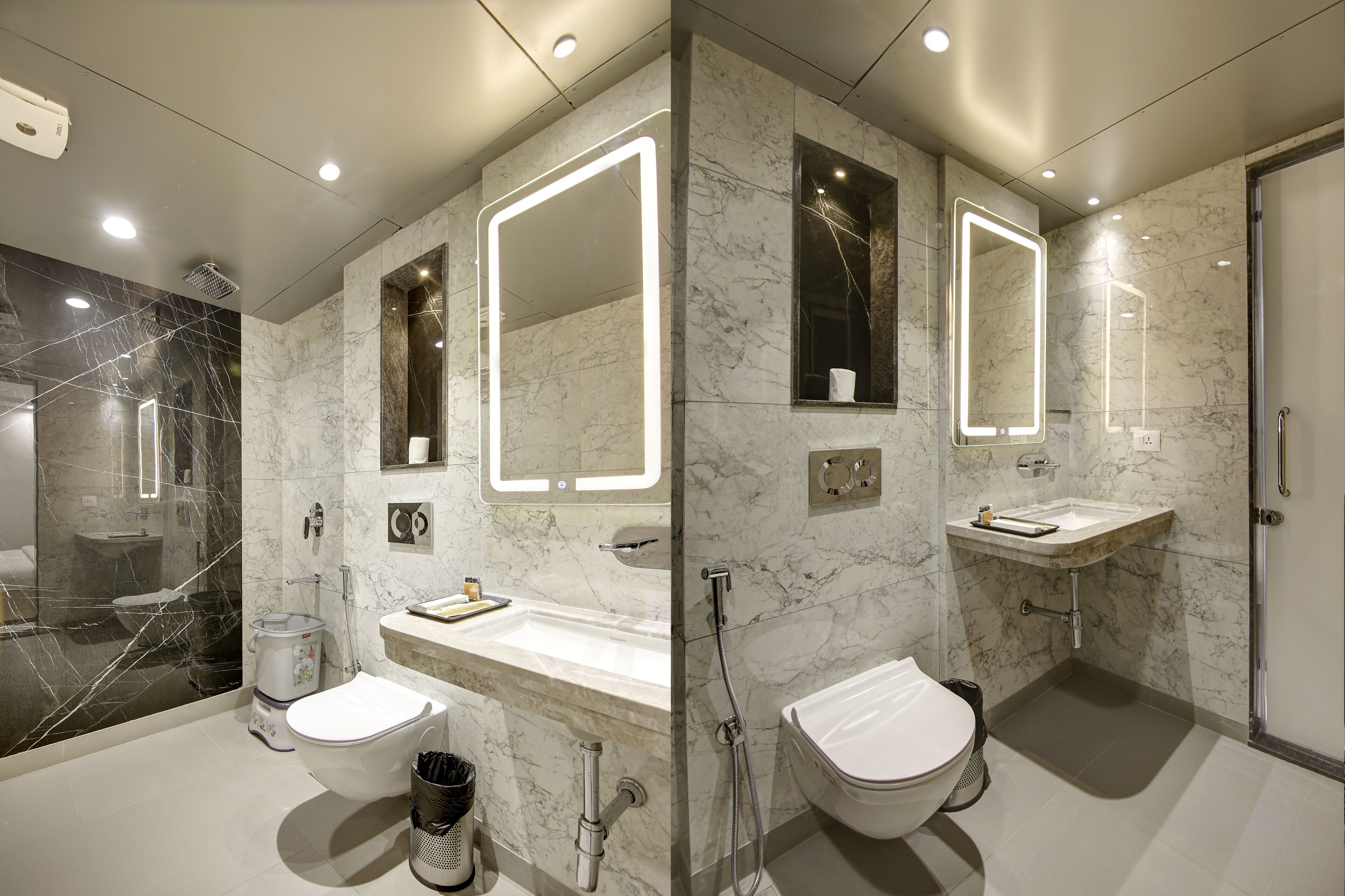 Un baño moderno con tocador de mármol, cabina de ducha de vidrio y inodoro separado.