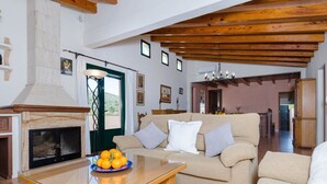 A spacious living area with a fireplace, a sofa set, and a dining table. - Pula ViÑas - Villa With Private Pool. Free Wifi (Son Servera, Illes Balears)