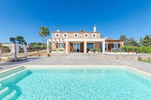 A modern villa with a swimming pool, stone facade, and a covered patio area. - El Paraiso (porto Cristo) - Villa With Pool (Porto Cristo, Illes Balears)
