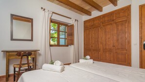 A bedroom with a large bed, wooden wardrobe, a desk with a chair, and a window with curtains. - Mercader - Villa With Private Pool In Alcúdia (Alcúdia, Illes Balears)