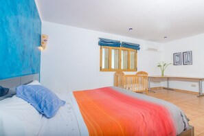 A bedroom with a bed, a desk, a chair, and a window with curtains. - Na Pont - Villa With Private Pool In Campos (Campos, Illes Balears)