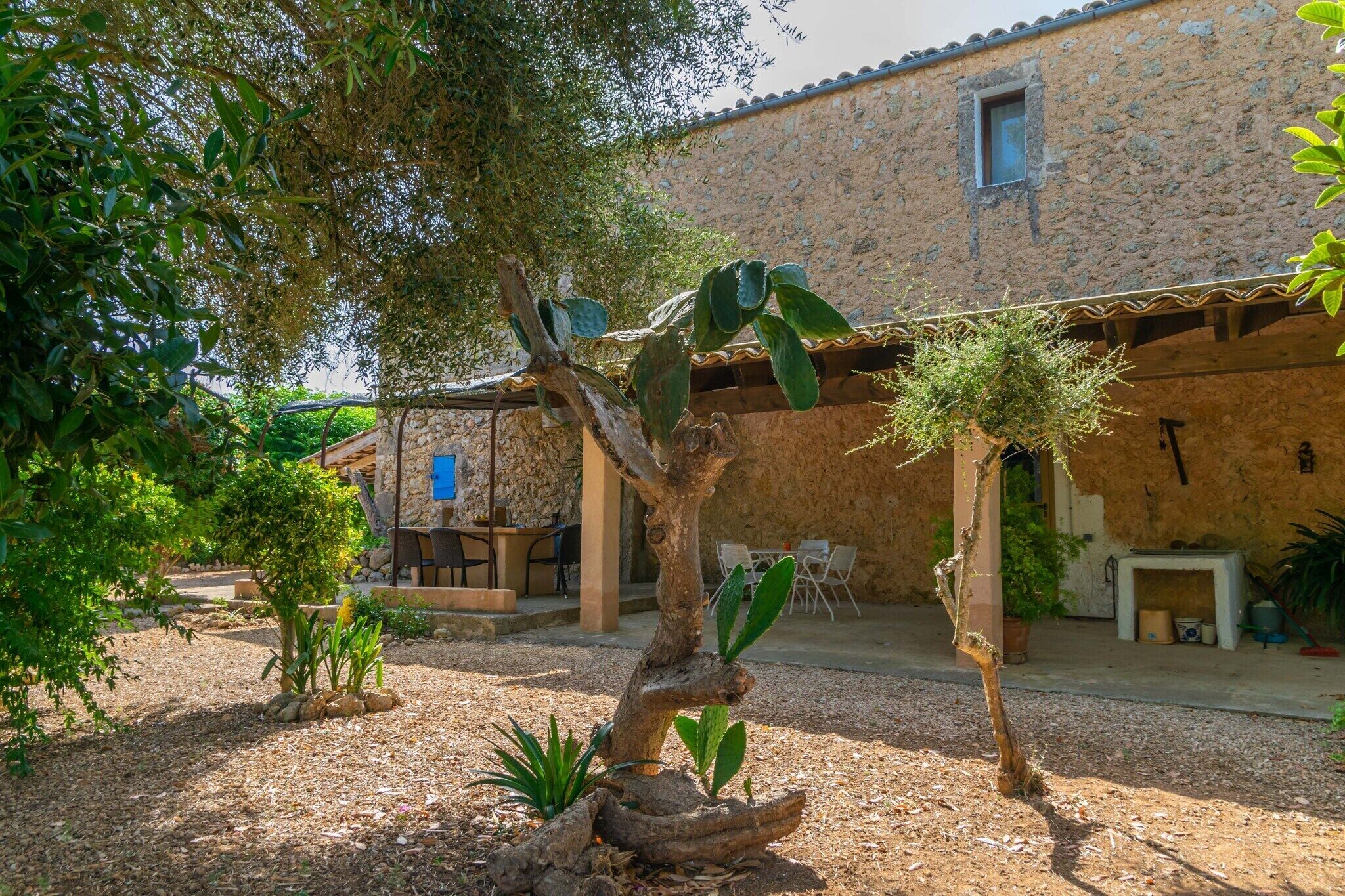 A rustic stone building with a covered patio area.
