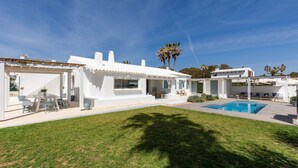 A modern white house with a swimming pool, a covered patio, and a well-maintained lawn. - Sa Blava - Villa With Private Pool. Free Wifi (, Illes Balears)