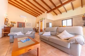 Cozy living area with sofas, coffee table, and dining space.