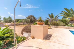 Relax in our serene garden, surrounded by lush greenery and a sparkling pool.