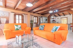 Relax in this inviting living area with a high ceiling and comfortable seating arrangement.