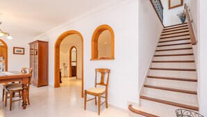 A staircase with wooden steps and a handrail, leading to a second floor.