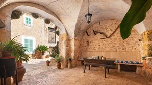 A rustic stone interior with a billiards table, potted plants, and a bench. - San Sole - Villa With Private Pool In Felanitx (, Illes Balears)