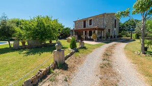 A stone house with a garden path leading to the entrance.
