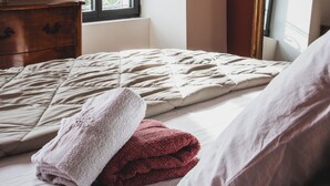 A bedroom with a large window, a wooden dresser, a bed with a patterned bedspread, and a mirror with a gold frame. - House in Provence, large garden and swimming pool ( 10 people ) in Orange (Orange)
