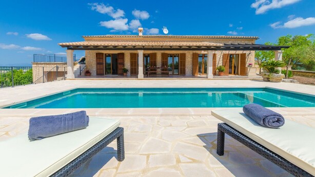 A poolside area with lounge chairs and a stone-tiled deck. - Son Roca - Villa With Private Pool In Montuïri (Montuïri, Illes Balears)