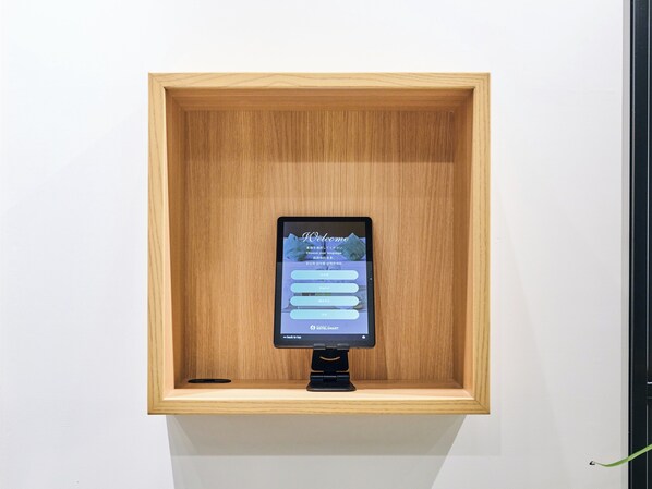 A tablet displaying a hotel website interface in a wooden display case. - HOTEL ALL IN TOKYO ASAKUSABASHI (Tokyo)