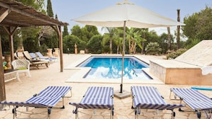 A pool area with lounge chairs and an umbrella. - Canaus - Villa With Private Pool In Porreres (Porreres, Illes Balears)