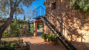 A stone building with a metal staircase leading to a balcony. - Canaus - Villa With Private Pool In Porreres (Porreres, Illes Balears)