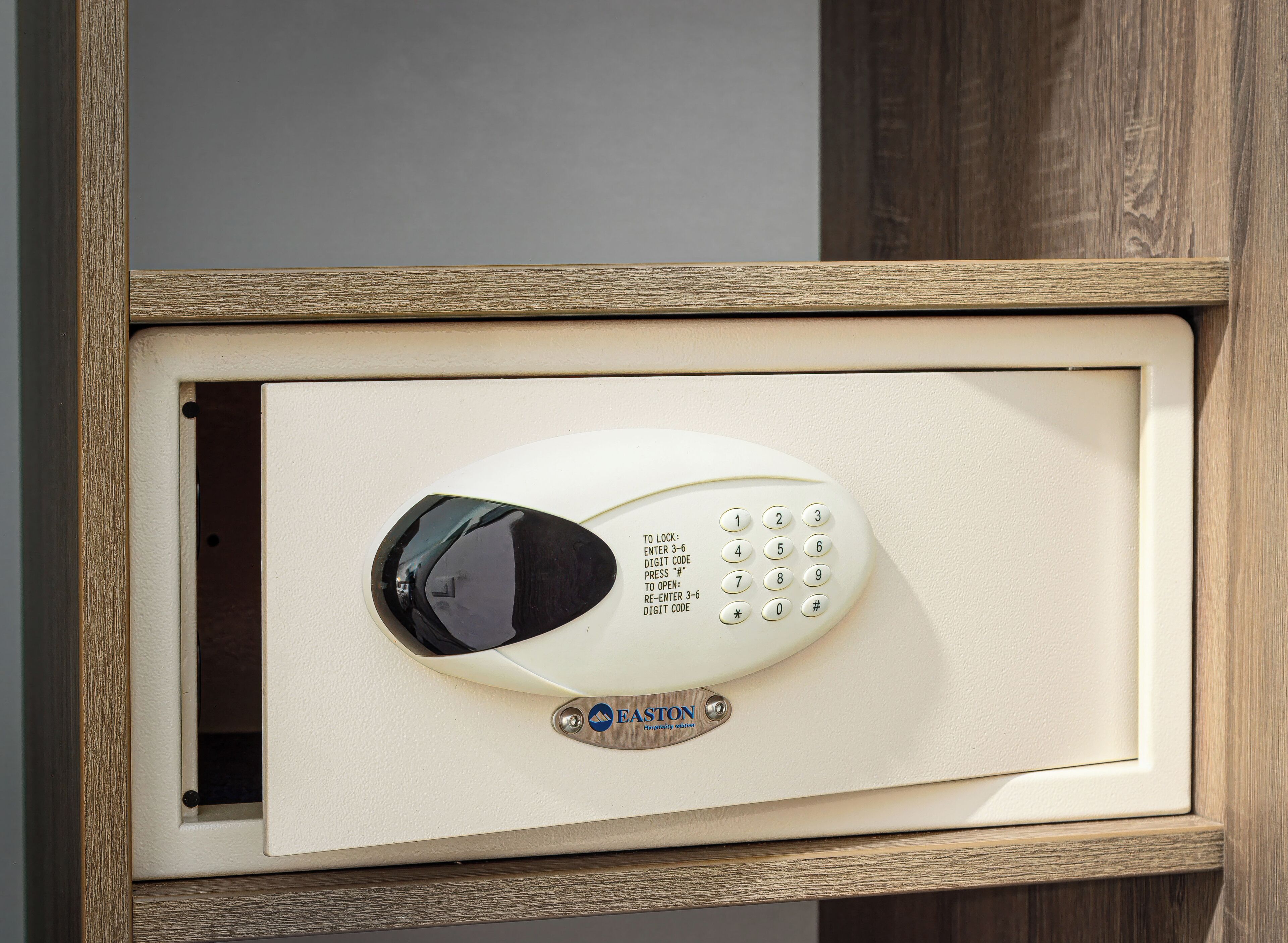 A keypad lock with instructions for entering a code, mounted on a beige door frame.