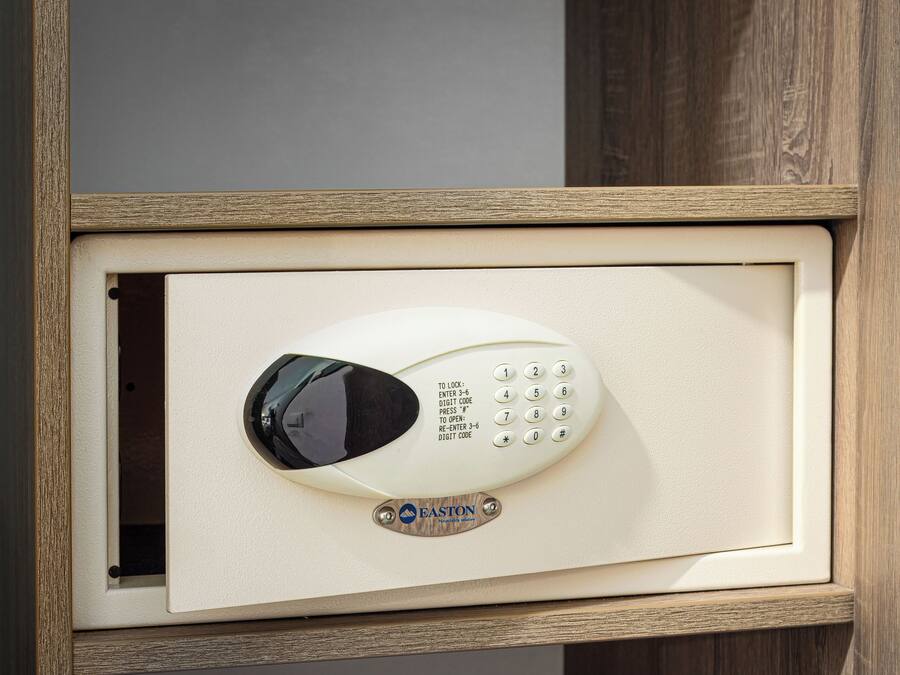 A keypad lock with instructions for entering a code, mounted on a beige door frame.