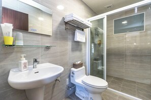 A modern bathroom with a sink, toilet, and glass shower enclosure. - TurnLeftHome (Wujie)