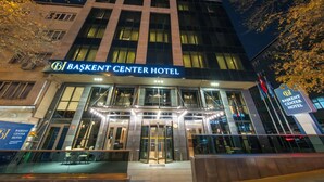 The exterior of the BASKENT CENTER HOTEL with a glass entrance and illuminated signage. - Baskent Center Hotel (Ankara)