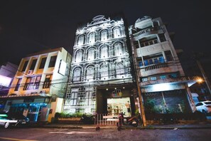 A building with a large, ornate facade and a shop entrance. - Here We Go Bangkok (Bangkok)