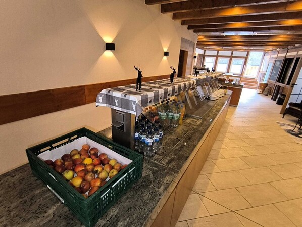 Enjoy a sumptuous spread of fresh fruits and beverages at our buffet, served in a stylish setting with comfortable seating.