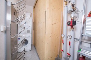 A laundry room with a washing machine, drying racks, and plumbing. - Pinzgau Ski Chalet Retreat With Balcony (Wald im Pinzgau)
