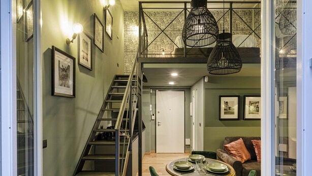 A modern interior with a staircase, dining area, and a loft space. - Elaisa s House - RS (Genoa)