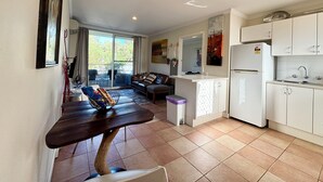 A modern kitchen with white cabinets, a built-in oven, and a sink. - City Escape Getaway Subiaco 1Bedrm Unit (Subiaco)