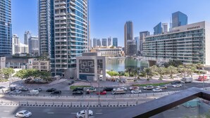 A modern urban area with high-rise buildings, a marina, and a roundabout with cars and pedestrians. - New Listing | JBR Beach Gem | Czechin | 1BD (Dubai)