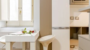 A modern kitchen with white cabinetry, a white countertop, and a stainless steel sink. - [salernostays] Central apt by duomo | Retro Vibes (Salerno)