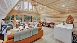 Un vaste espace de vie de style loft comprenant un grand coin repas, un coin salon confortable et une cuisine moderne.