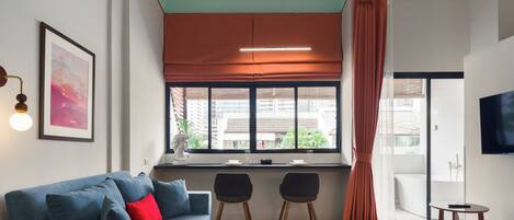 Design Studio Suite, 1 Bedroom, Bathtub, City View | In-room safe, individually decorated, individually furnished, desk