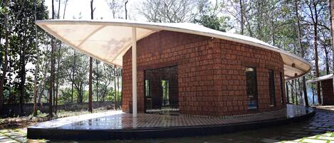 A modern brick building with a covered patio area.