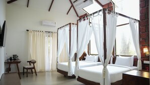 A hotel room with two beds, a desk, a chair, and a TV. - TGI Redolent Resort & Spa (Somvarpet)