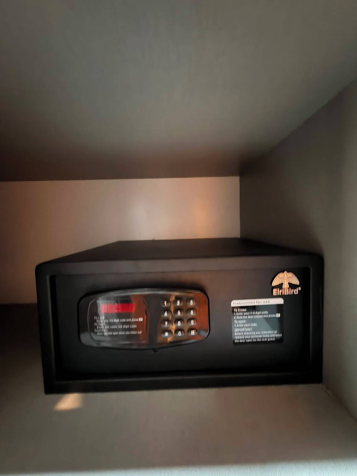 A black Elbirid electronic device with a keypad and a display screen, likely a security or control panel.
