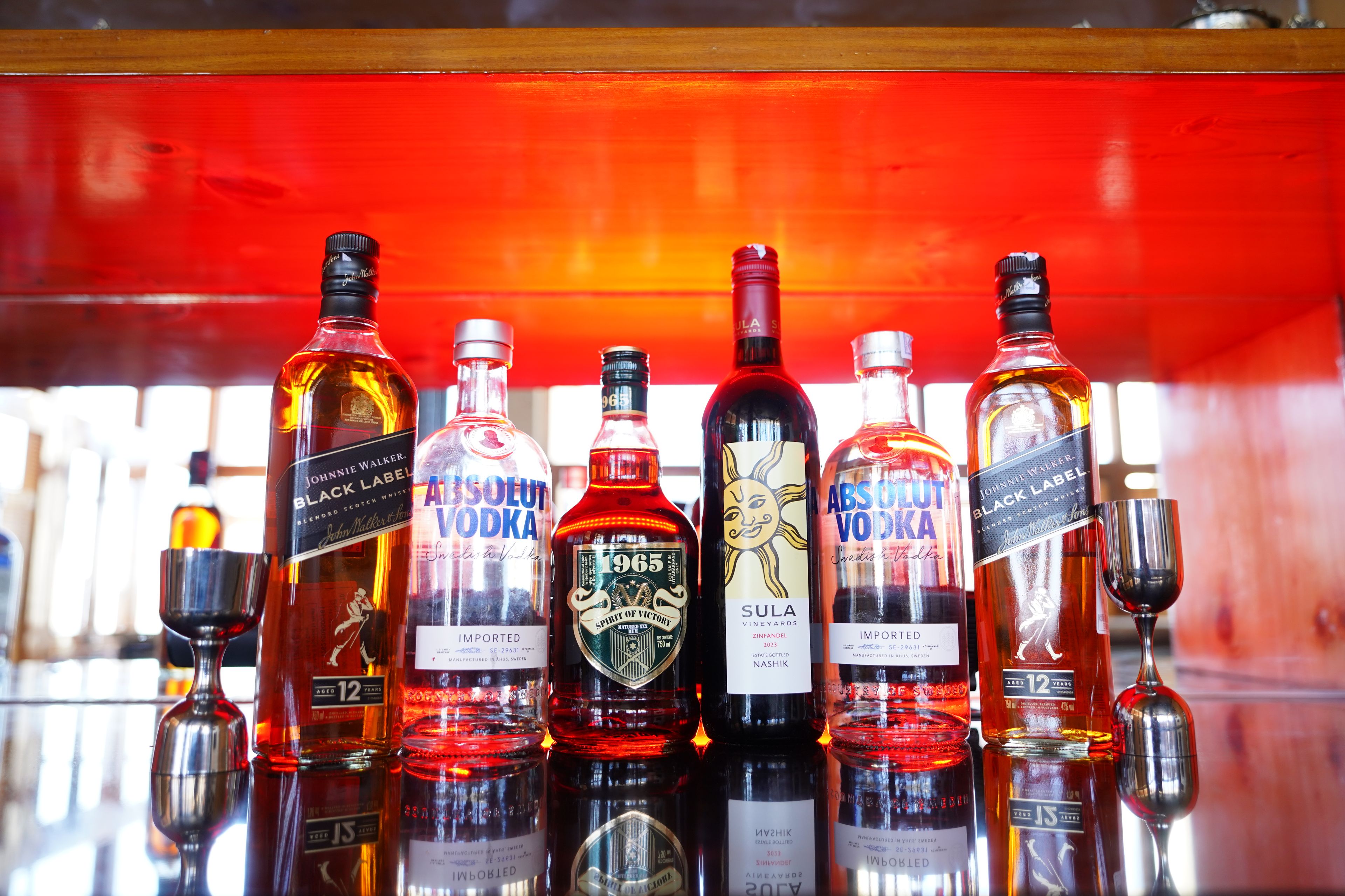 A selection of alcoholic beverages on a bar counter.