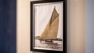 A framed photograph of a sailboat on water.