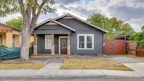 A two-story house with a dark blue exterior, a front porch, and a wooden fence. - ~ 2 Mi to Dtwn San Antonio: Comfy Home w/ Yard! (San Antonio)