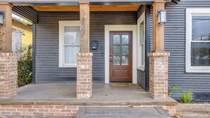 A house with a wooden porch, a brown front door, and a mailbox. - ~ 2 Mi to Dtwn San Antonio: Comfy Home w/ Yard! (San Antonio)