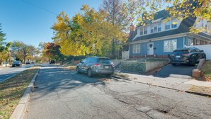 A residential street with houses, parked cars, and autumn foliage. - 1 Mi to Train Station: Quiet Apartment in Newark (Newark)