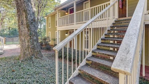 A two-story house with a wooden staircase and a porch. - Private Deck, 1 Block From The Square (Oxford)