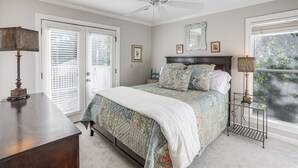 A bedroom with a bed, a desk, a ceiling fan, and a window with blinds. - Private Deck, 1 Block From The Square (Oxford)