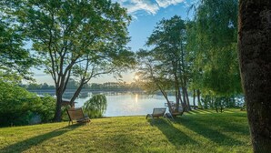 A lakeside view with two lounge chairs and a grassy area. - Vacation apartment "Fischadler" with terrace in Jabel an der Müritz (Jabel)