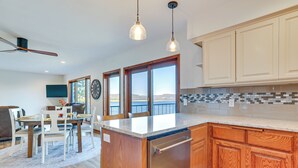 A modern kitchen with wooden cabinets, a built-in dishwasher, and a large island with a sink. - Dock & Views: Waterfront Home in Wabasha! (Wabasha)