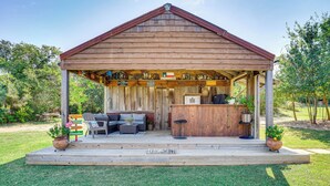 A wooden structure with a porch, seating area, and a bar. - 4 Mi to Dtwn: Home w/ Pool in Stephenville! (Stephenville)